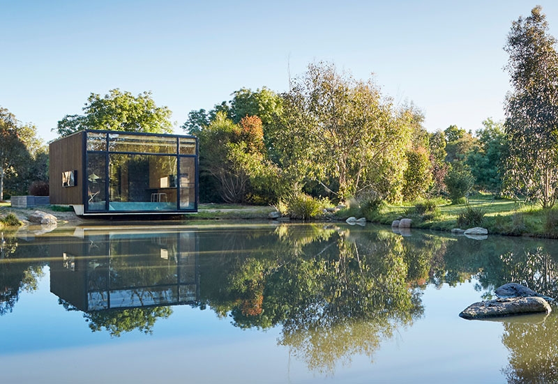 A slow living cabin where fold-out walls transform the space from studio to home
