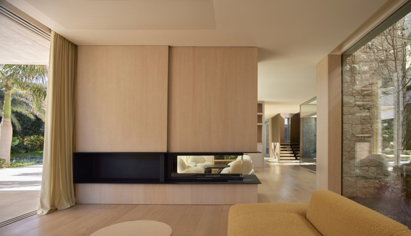 Inside a modern villa wrapped in stone walls