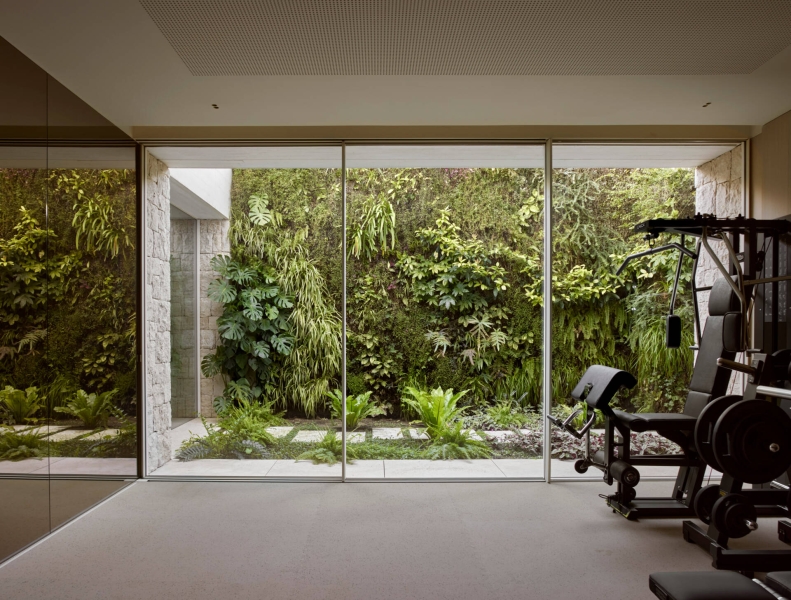 Inside a modern villa wrapped in stone walls