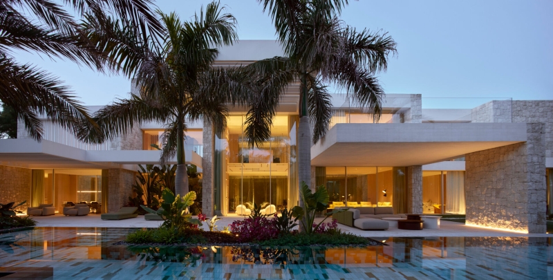 Inside a modern villa wrapped in stone walls