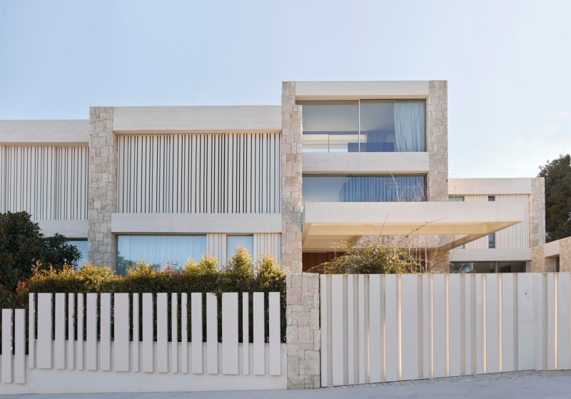Inside a modern villa wrapped in stone walls