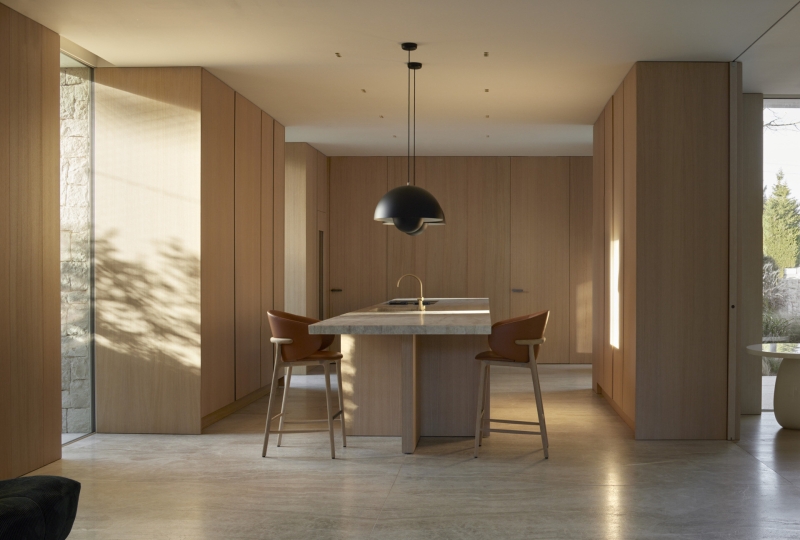 Inside a modern villa wrapped in stone walls