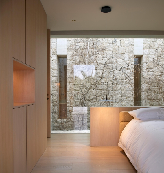 Inside a modern villa wrapped in stone walls