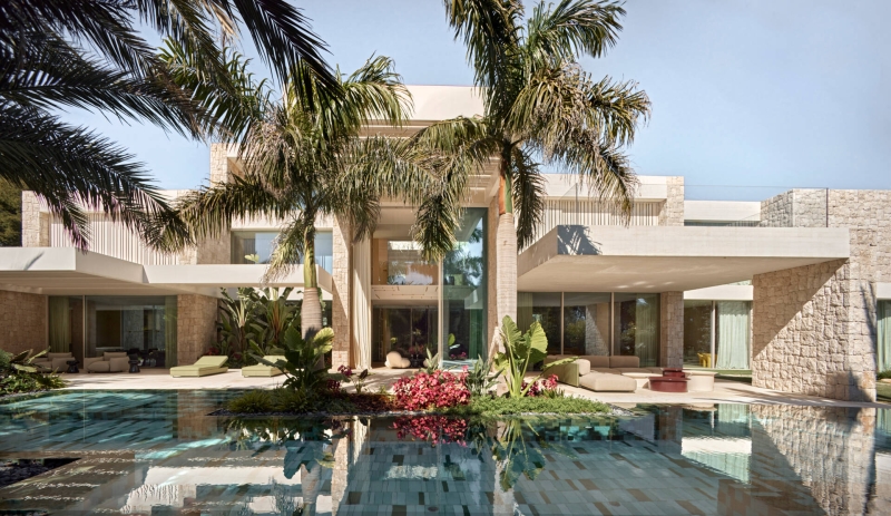 Inside a modern villa wrapped in stone walls