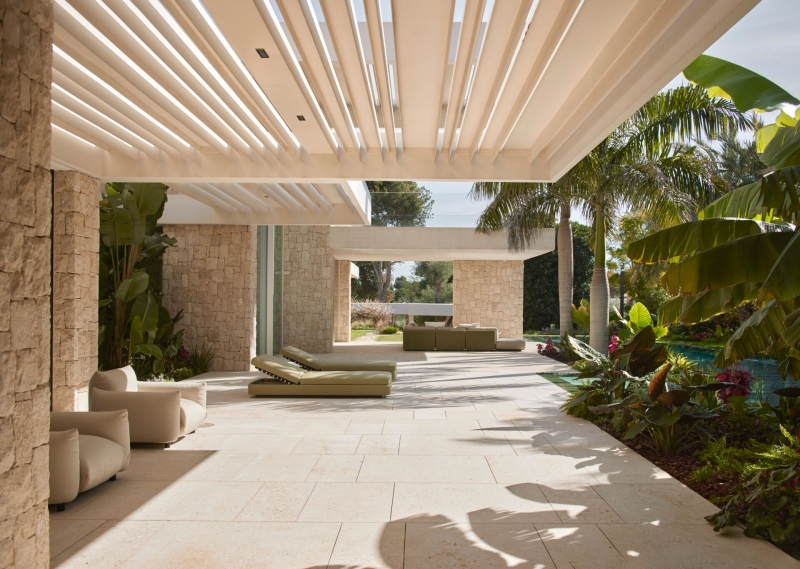 Inside a modern villa wrapped in stone walls