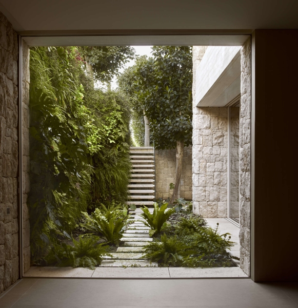 Inside a modern villa wrapped in stone walls