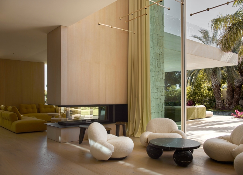 Inside a modern villa wrapped in stone walls