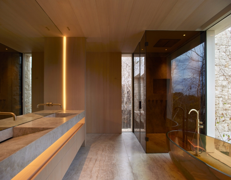 Inside a modern villa wrapped in stone walls