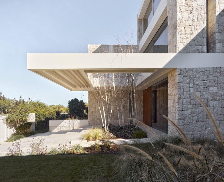 Inside a modern villa wrapped in stone walls