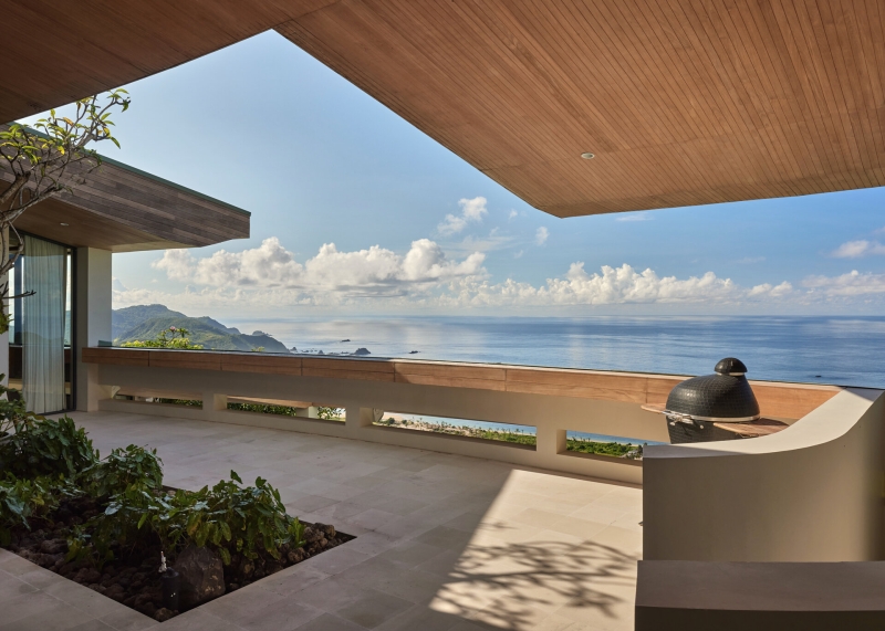 The mountain appears to be slowly consuming this modern home