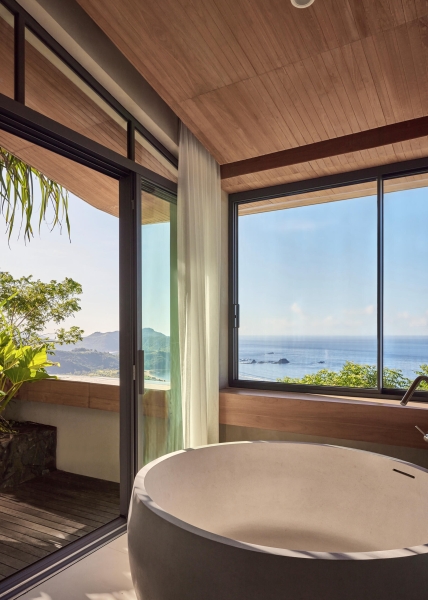 The mountain appears to be slowly consuming this modern home