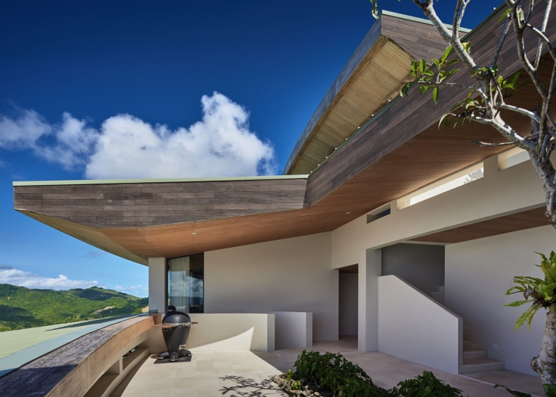 The mountain appears to be slowly consuming this modern home