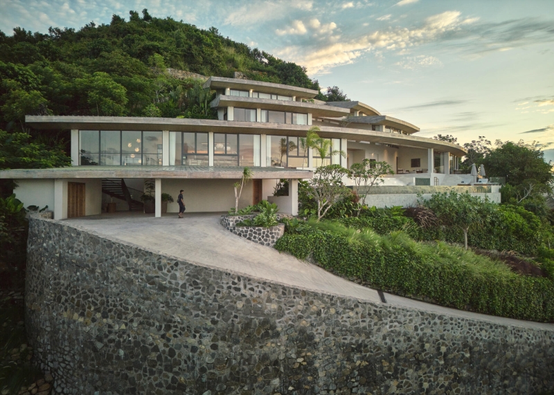 The mountain appears to be slowly consuming this modern home