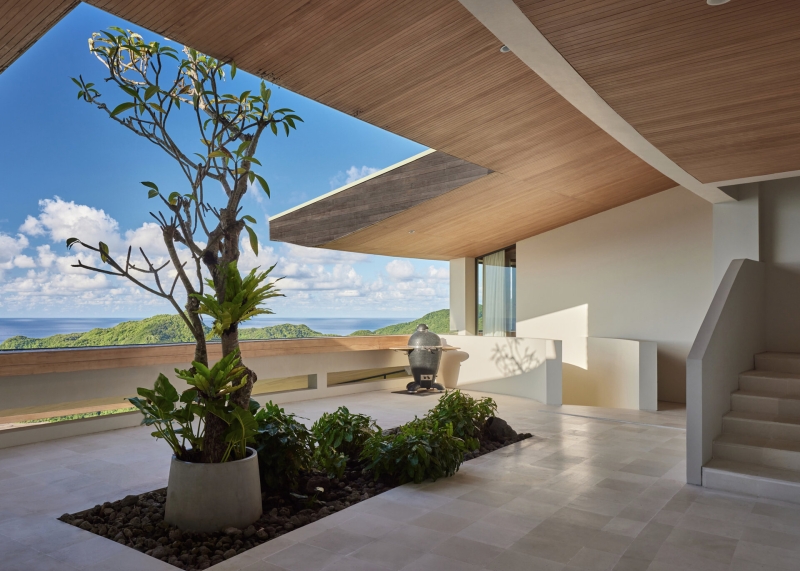 The mountain appears to be slowly consuming this modern home
