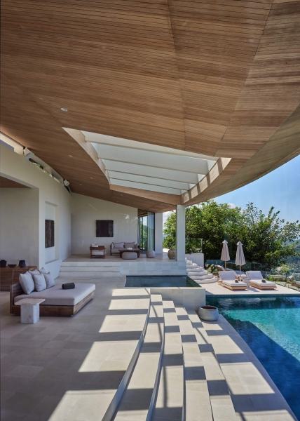 The mountain appears to be slowly consuming this modern home