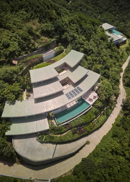 The mountain appears to be slowly consuming this modern home