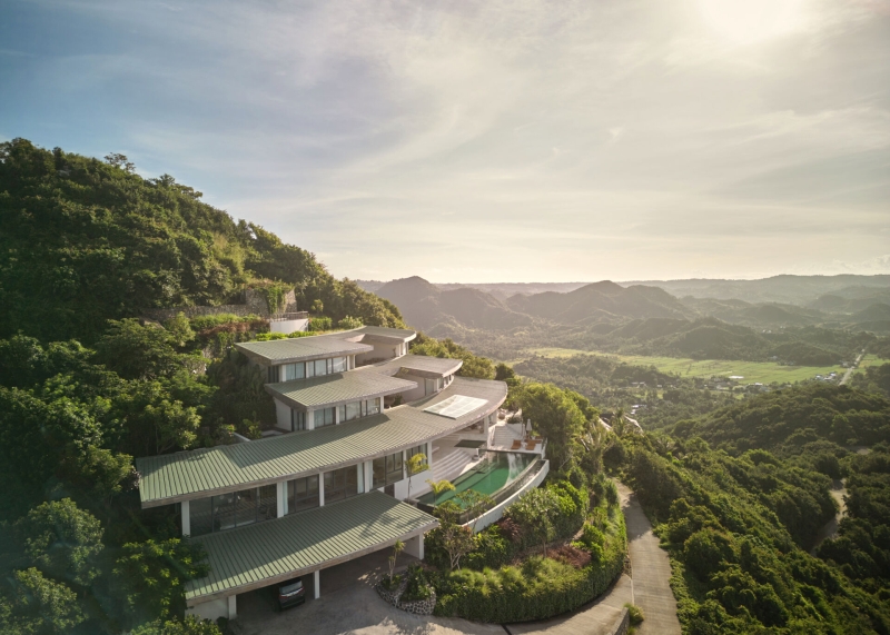The mountain appears to be slowly consuming this modern home