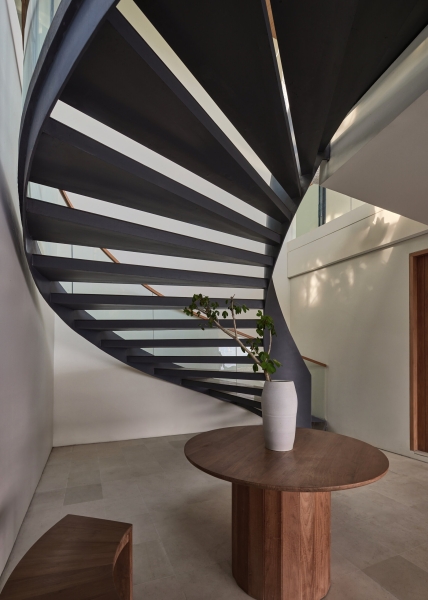 The mountain appears to be slowly consuming this modern home