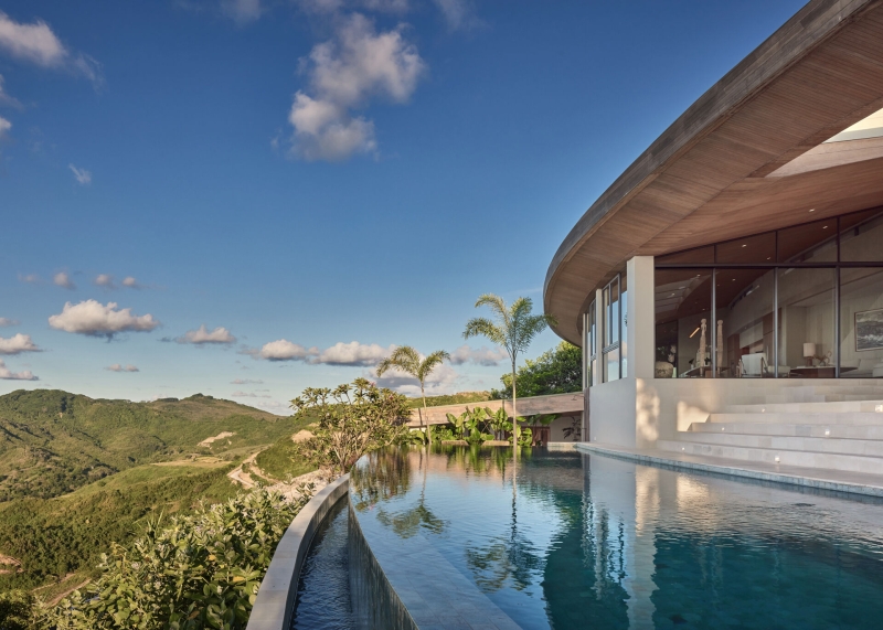 The mountain appears to be slowly consuming this modern home