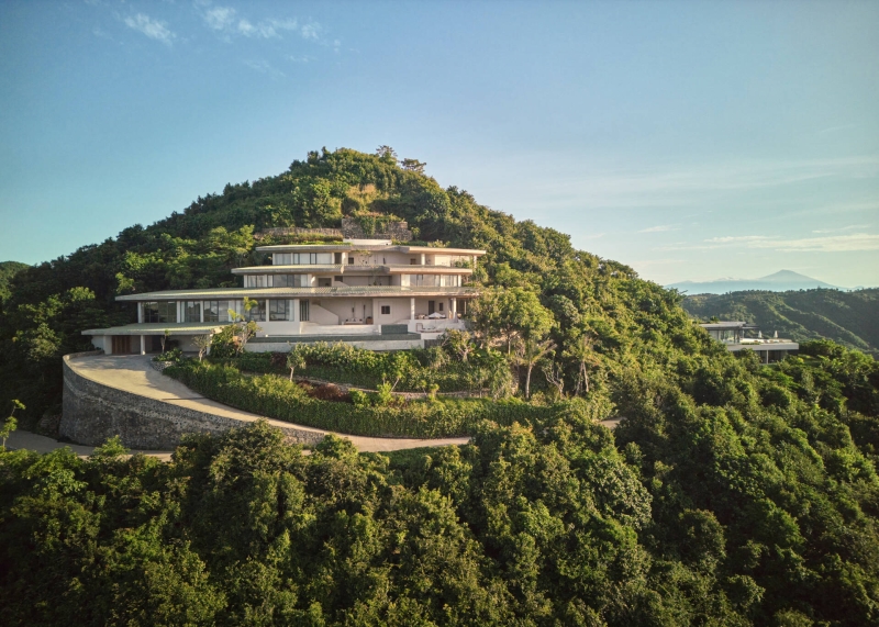 The mountain appears to be slowly consuming this modern home