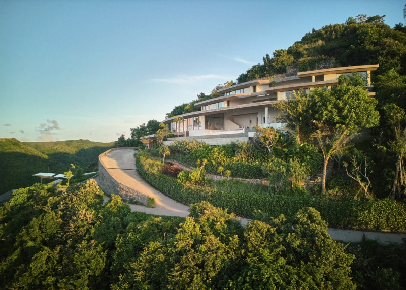 The mountain appears to be slowly consuming this modern home