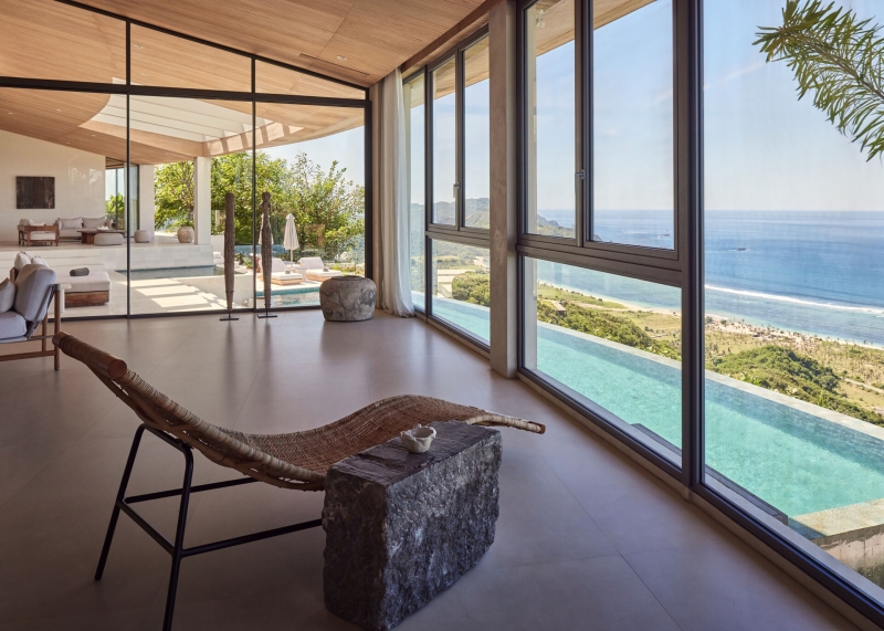 The mountain appears to be slowly consuming this modern home