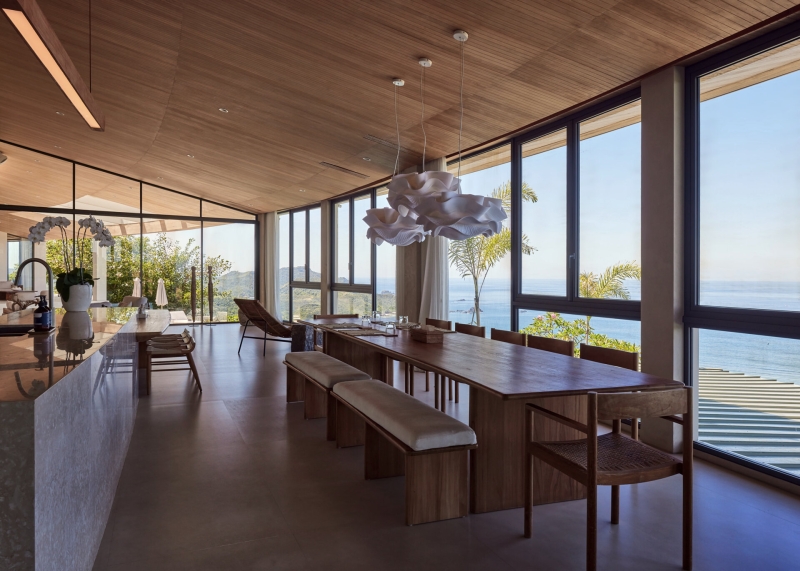 The mountain appears to be slowly consuming this modern home