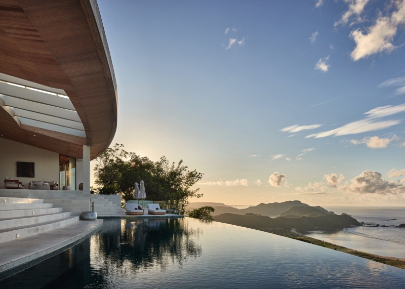 The mountain appears to be slowly consuming this modern home