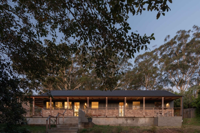 Inside the wraparound porch home glowing at golden hour