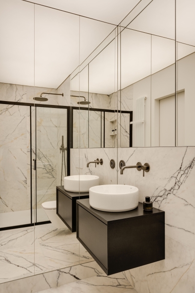 This small apartment feels twice the size, because the bathroom hides in a mirrored box