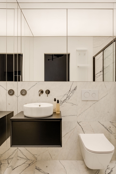 This small apartment feels twice the size, because the bathroom hides in a mirrored box