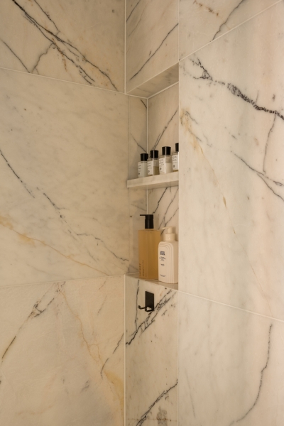 This small apartment feels twice the size, because the bathroom hides in a mirrored box