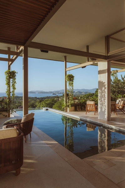 Terrace Living and a Cantilevered Pool in a Hillside Home