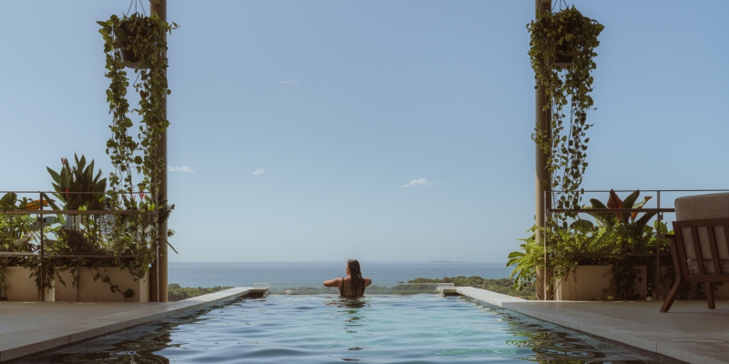 Terrace Living and a Cantilevered Pool in a Hillside Home