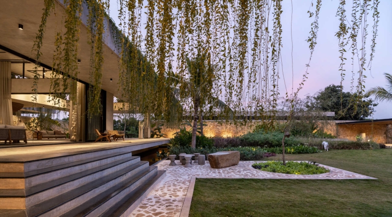 Tour this home that uses Stone Walls and Hanging Greens to Shape Every Space