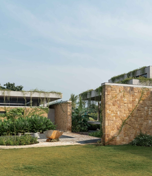 Tour this home that uses Stone Walls and Hanging Greens to Shape Every Space