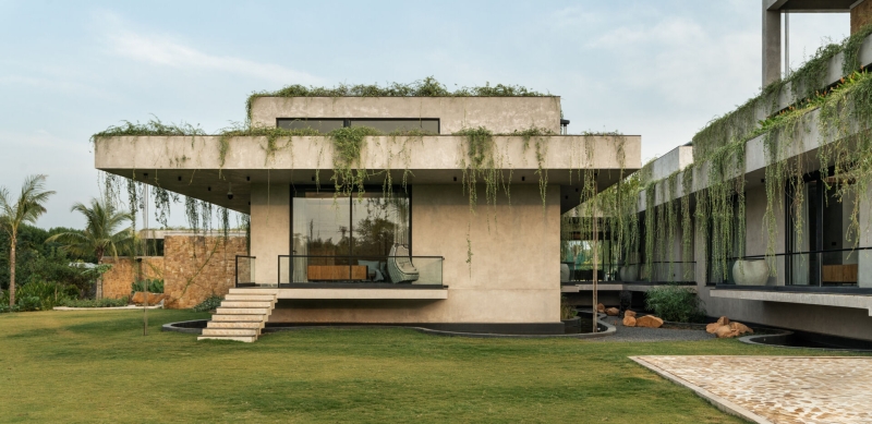 Tour this home that uses Stone Walls and Hanging Greens to Shape Every Space