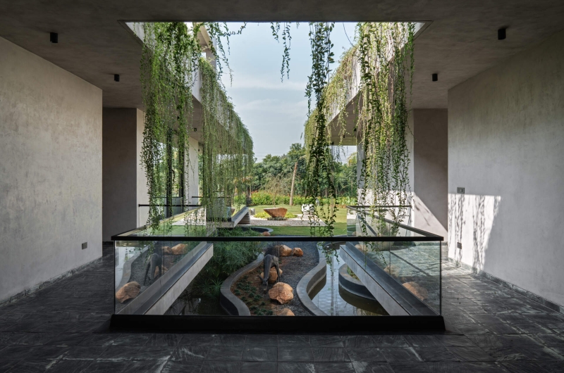 Tour this home that uses Stone Walls and Hanging Greens to Shape Every Space