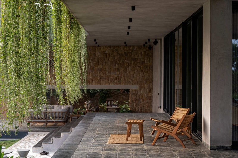 Tour this home that uses Stone Walls and Hanging Greens to Shape Every Space