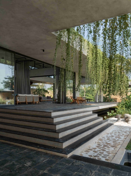 Tour this home that uses Stone Walls and Hanging Greens to Shape Every Space