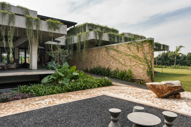 Tour this home that uses Stone Walls and Hanging Greens to Shape Every Space