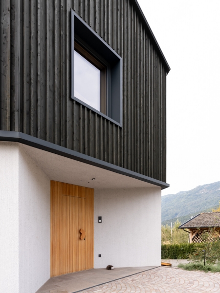 A Bold Black House Rises From a Landscape of Orchards