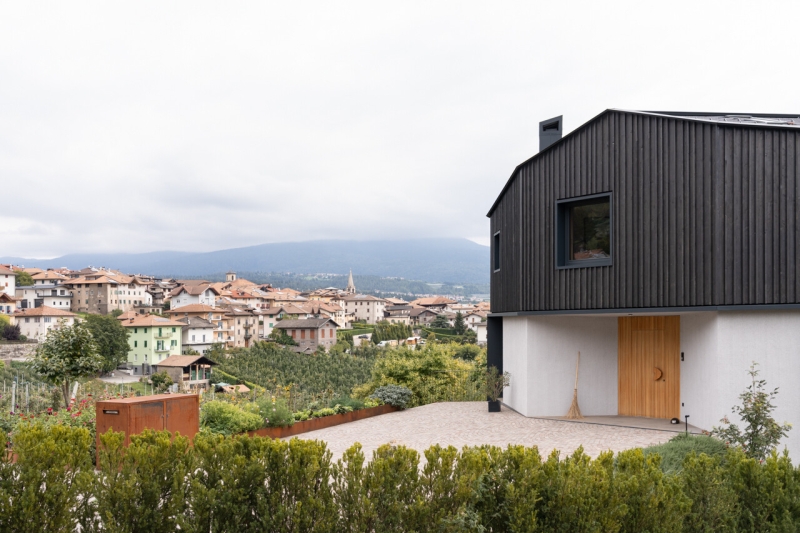 A Bold Black House Rises From a Landscape of Orchards