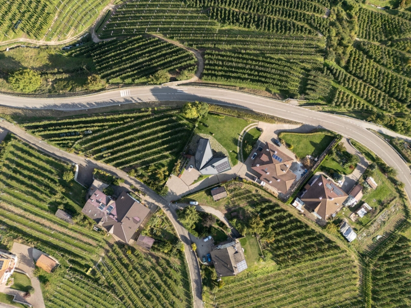 A Bold Black House Rises From a Landscape of Orchards