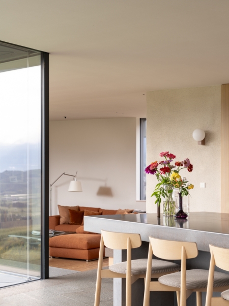 A Bold Black House Rises From a Landscape of Orchards