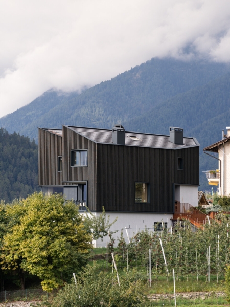 A Bold Black House Rises From a Landscape of Orchards