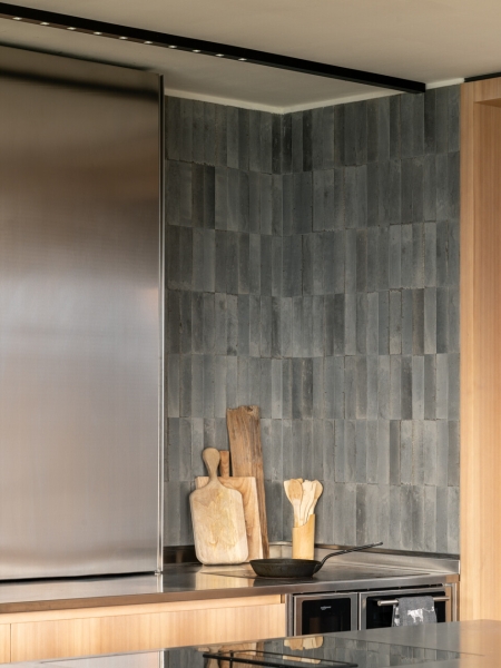 A Bold Black House Rises From a Landscape of Orchards