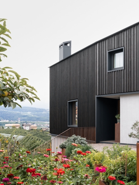 A Bold Black House Rises From a Landscape of Orchards