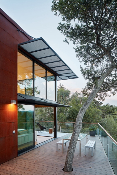 The Hillside House Wrapped in Rusted Steel with a Bright Yellow Surprise