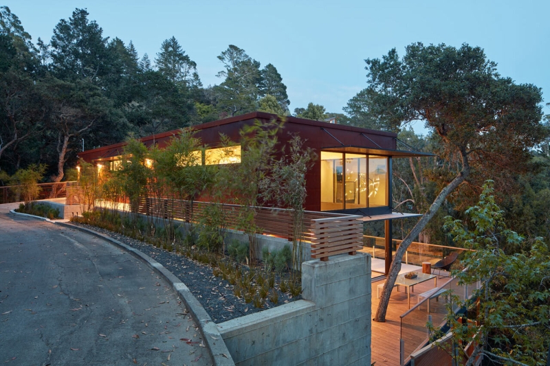 The Hillside House Wrapped in Rusted Steel with a Bright Yellow Surprise
